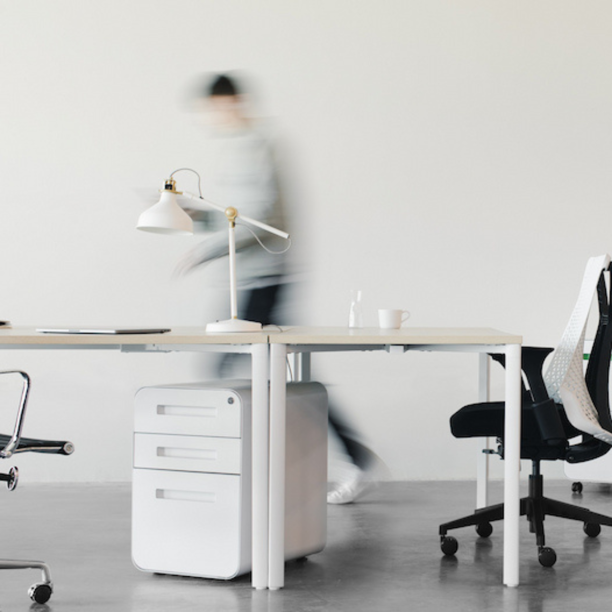 man walking fast in office blurred out